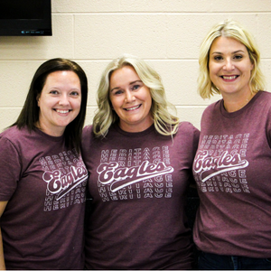 Three ladies with HES Shirts smiling for the camera
